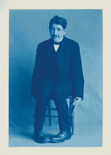 Unidentified friend of Frances Benjamin Johnston, seated, full length, facing front, leaning slightly forward.